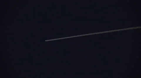 A UFO, asteroid or rocket moves across the night sky leaving a bright trail Stockbeeldmateriaal 55527007