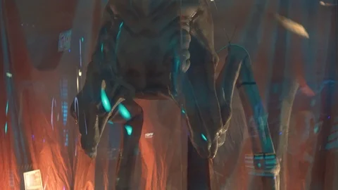 Ufo creature on two massive legs. Located behind clear glass with reflections.Bo 스톡 동영상 98865759