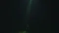 The UFO shines bright light on the male on a dark background 4k or 4k+ Resolution