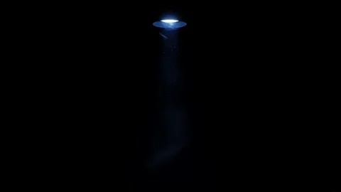 UFO spaceship emitting a glowing light beam during alien abduction concept Stock Footage 330005244