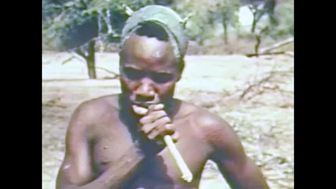 UGANDA - 1955 - In this documentary, a man brushes his teeth with a stick. Stock Footage 341982747