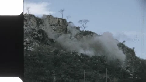 Uganda 1970s, Tororo quarry explosion, blasting rock on hillside Stock Footage 313506504