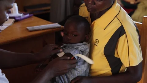 Ugandan baby's mid-upper arm circumference is being measured. Stock Footage 104265572