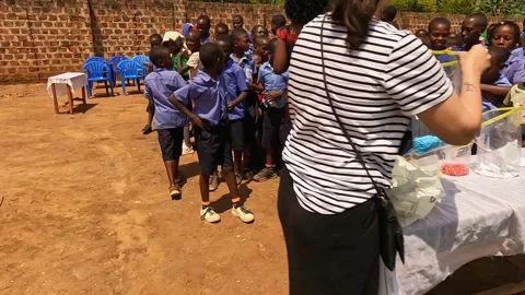 Ugandan school children queue for beads Stock Footage 334580112