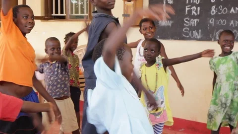 A Ugandan teacher doing physical execrices and games with children. Stock Footage 104265168