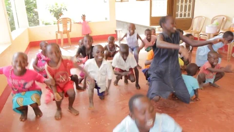A Ugandan teacher doing physical execrices and games with children. Stock Footage 104265182