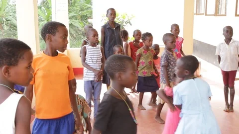 A Ugandan teacher doing physical execrices and games with children. Stock Footage 104265216