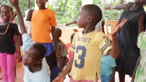 A Ugandan teacher doing physical execrices and games with children. Stock Footage 104265252