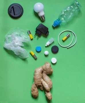 Ugly ginger root with various types of household waste, incandescent lamps, b Stock Photos