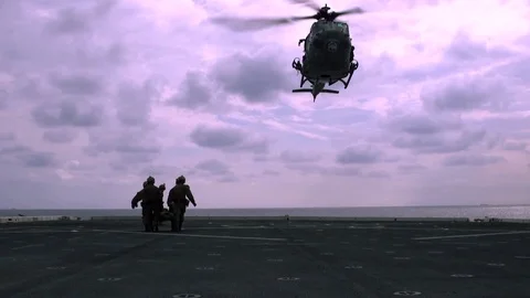 UH-1Y Venom Helicopter pulls up a package with a rope 1 Stock Footage 110794788