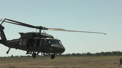UH-60 Black Hawk taking off with static line parachutists Stock Footage 114490129