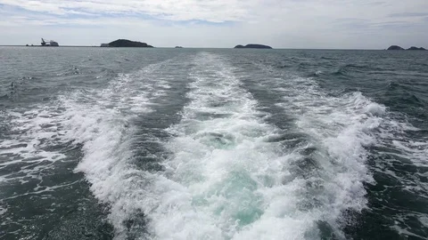 Fishing speedy boat prop wash, white wake on the blue ocean sea