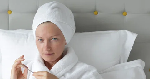 UHD 4K Pan left looking camera smiling face happy woman towel face polish nail Stock Footage 38000805