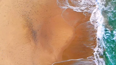 UHD 4K Vertical aerial drone view of splashing waves on multicolored beach,italy Stock Footage 103993611