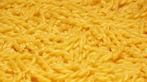 UHD closeup shot of the dry Gemelli pasta on a rotating stand Stockbeeldmateriaal 102492414