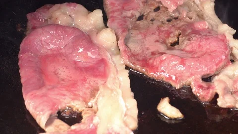 UHD closeup of the thin sliced marbled beef frying on the iron 動画素材 109140136