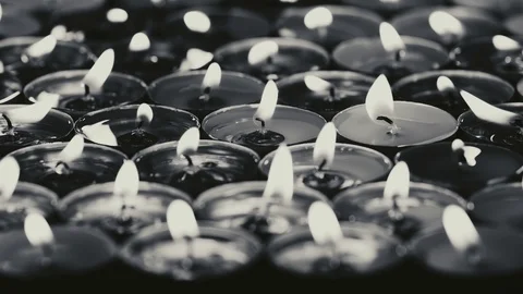 UHD dramatic monochrome of candles burning in the dark Stock-Footage 95683429