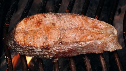 UHD shot of a single salmon steak on the grill Stock-Footage 94176971