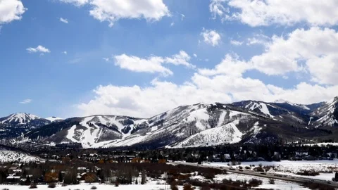 UHD time-lapse of clouds and snow-covered Wasatch Mountains, Park City, Utah. Stock Footage 99928222