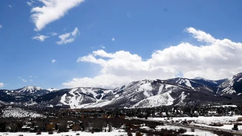 UHD Time-lapse of clouds moving over snow-covered Park City, Utah. Stock Footage 98007611