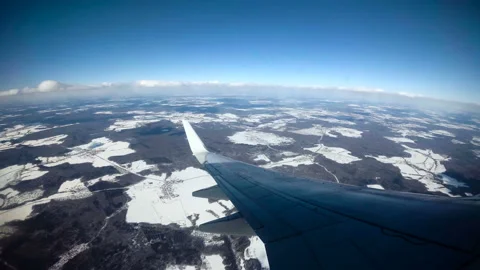 UHD Wing of an airplane flying above the clouds with blue sky Stock Footage 88293465