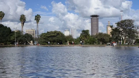 Uhuru Park boating lake with people walking around on a sunny day, Nairobi Stock Footage 84269953