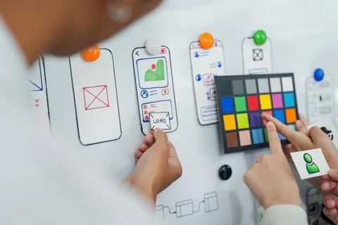 UI designer and UX developer brainstorm idea to design the application interface Stock Photos