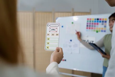 UI designer and UX developer brainstorm idea to design the application Stock Photos