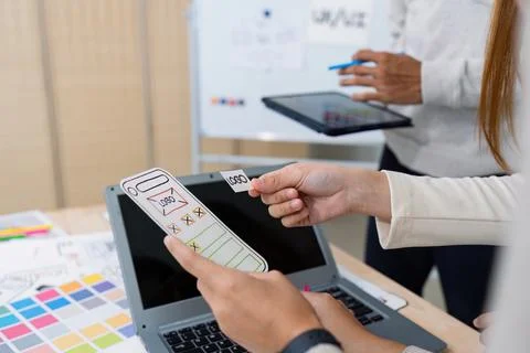 UI designer and UX developer brainstorm idea to design the application interface Stock Photos