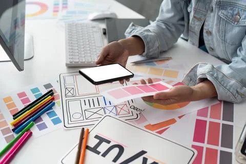 UI designer and UX developer brainstorm idea to design the application interface Stock Photos