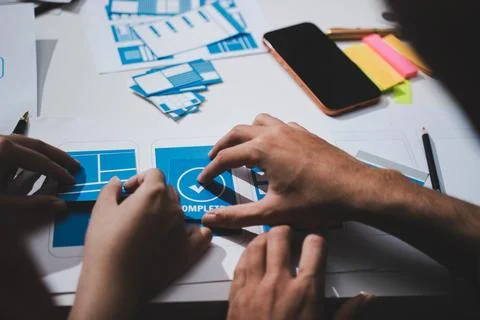 UI designer and UX developer brainstorm idea to design the application appe.. Stockfoto's