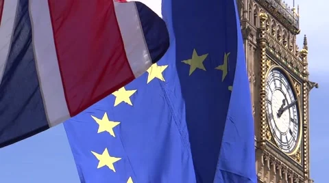 UK and EU flags are waving in front of BigBen Stock Footage