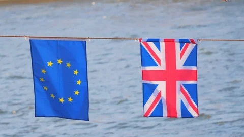 UK and EU flags on rope against water Stock Footage 108532607
