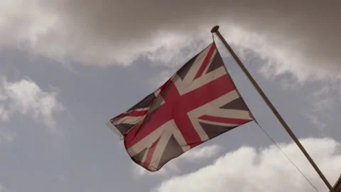 UK British Flag Flapping in Wind in Slow Motion with Dynamic Clouds Background Stock Footage 346751096