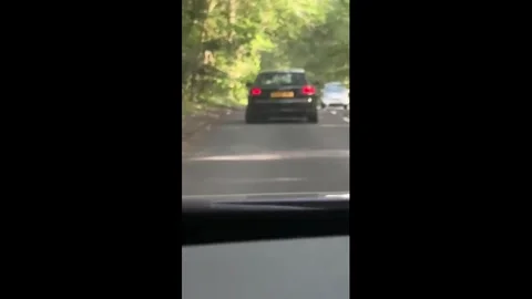UK: Car continues driving after tire detaches in Woking, England, UK Stock Footage 336238056