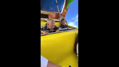 UK: Children react differently while riding pirate ship in Towyn, Wales, ... Stock Footage 343654381