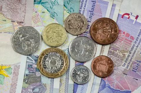 UK Currency Notes with One of Each UK Coin Stock Photos