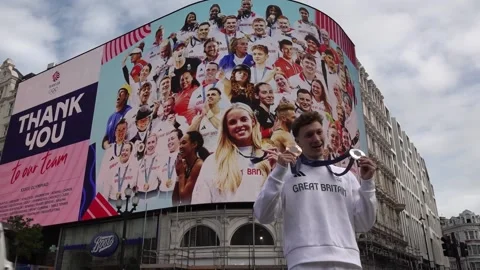 UK: Double medalist Noah Williams poses in front of a special Picadilly circ... Stock Footage 281754713