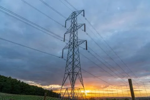 UK Electrical Pylon with high voltage Power lines at sunset Stock Photos