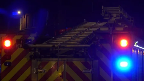 A UK Fire Engine with blue lights flashing at night 動画素材 292931558