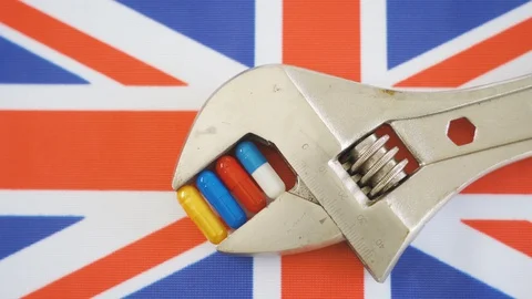 The UK flag and the silver wrench on the table Stock Footage 129338714