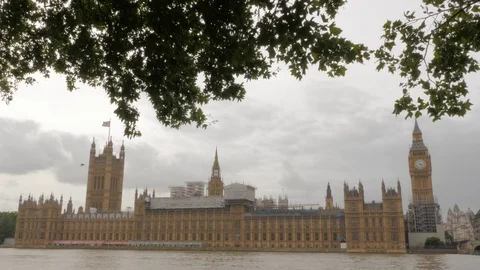 UK Houses of Parliament, cloudy day with River Thames Stock Footage