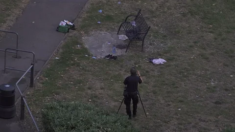 UK July 2019 - A camera flash illuminates the area around a pool of blood Stock Footage 113144511