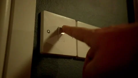 A UK light switched being turned on and off again Stock Footage 147048334