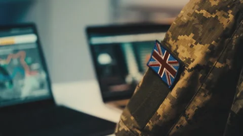 UK military commander studying intelligence data on computer, planning operation Stock Footage 264326708