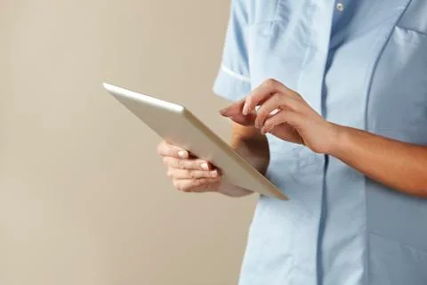 UK nurse using computer tablet Foto stock