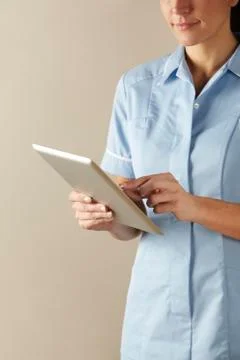UK nurse using computer tablet Stock Photos