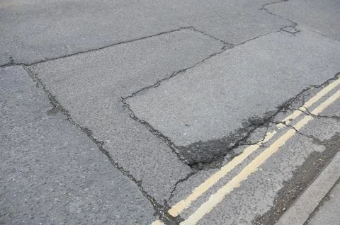 UK patchwork roads potholes, and recent repairs already falling apart. 写真素材