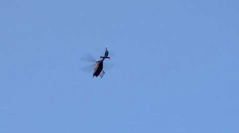 UK police helicopter hovering overhead in clear blue sky Video stock 41925892