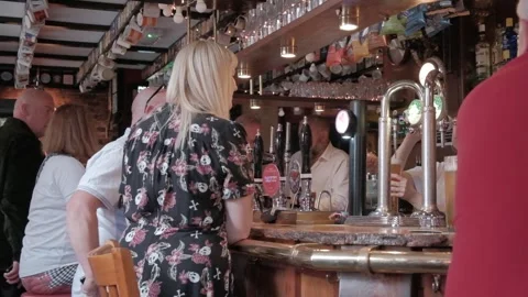 UK pub setting, drinking alcohol, pulling pints, people. Hull.UK.6.7.2024 Stock Footage 280462701